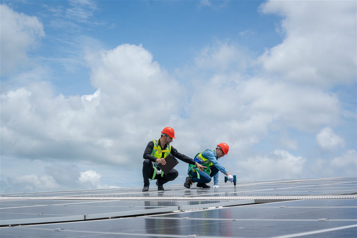 Engineers checking solar panels at an industrial facility